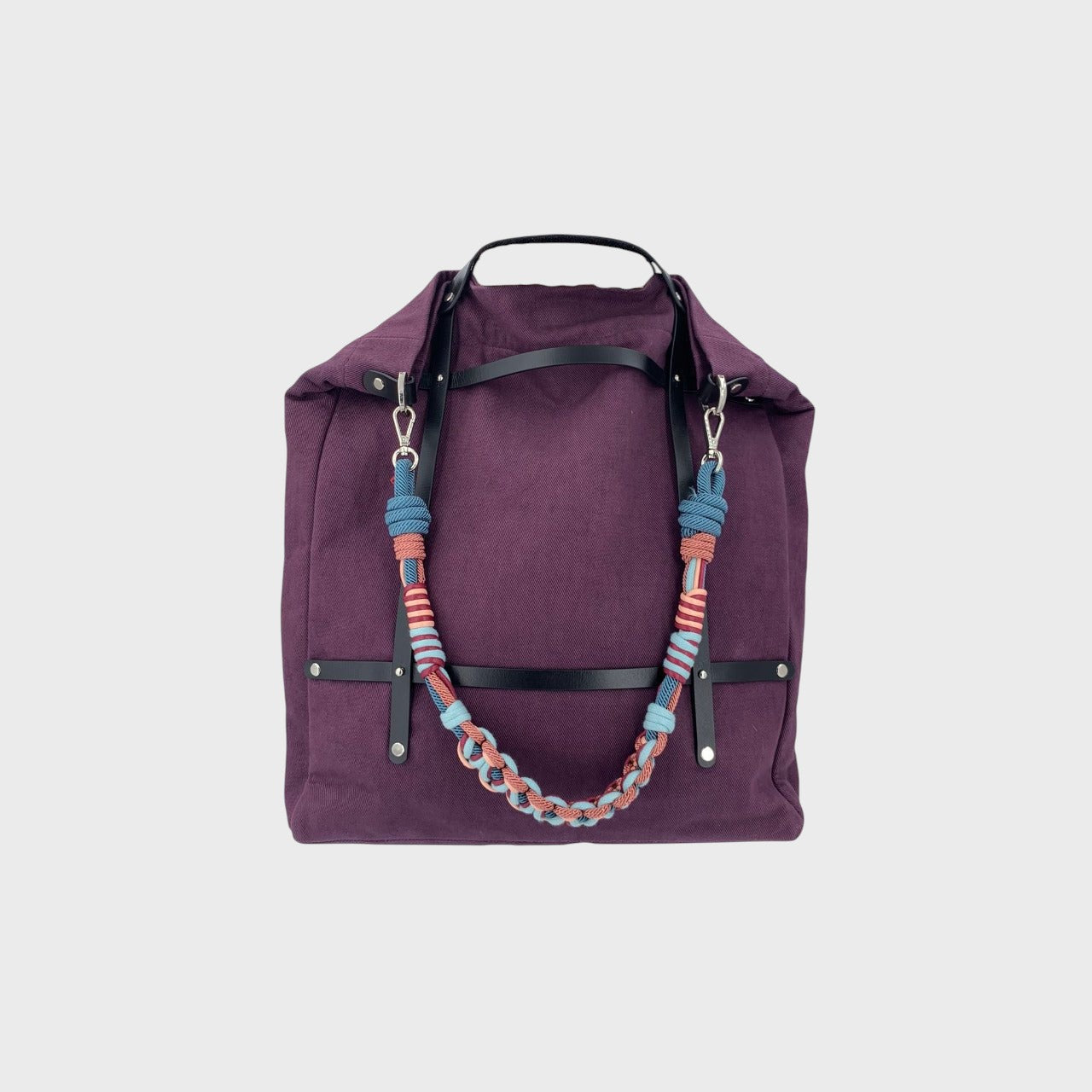 Multicolored braided macramé bag strap in light blue, soft pink, and dark blue shown on an OPTIMISTE aubergine bag.
