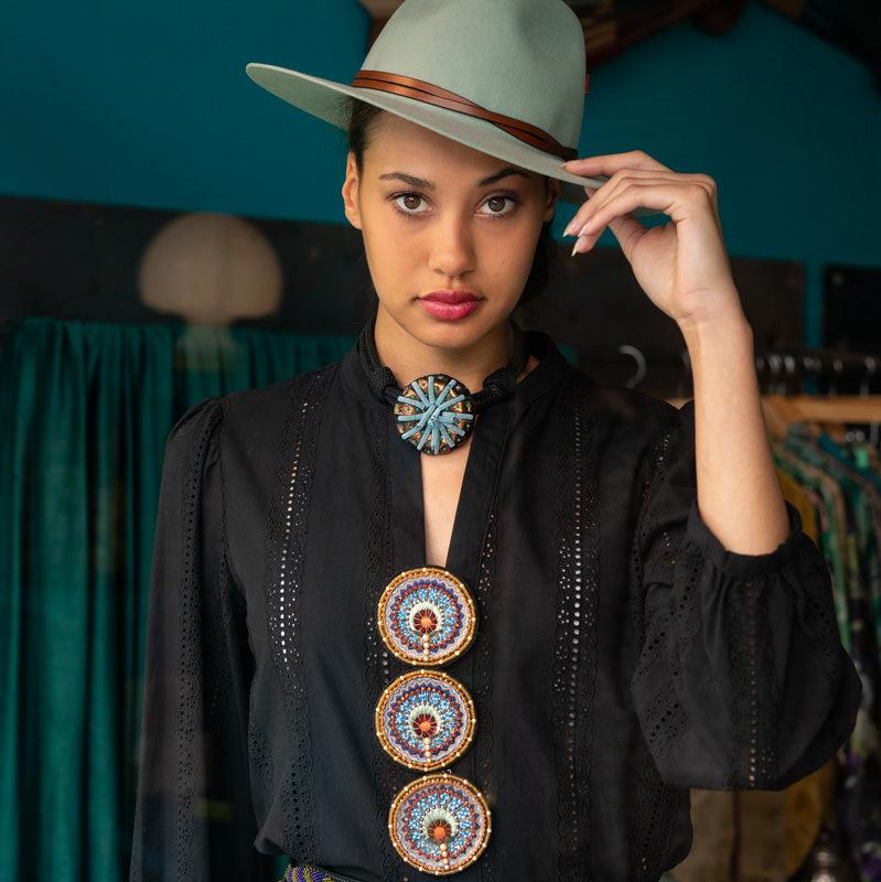 A model wearing three Sofia Brooch.