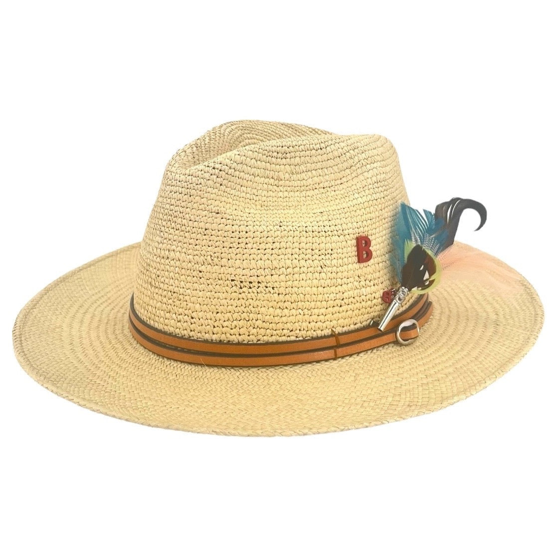 A straw hat with a leather band and a decorative feather brooch attached to the brim.