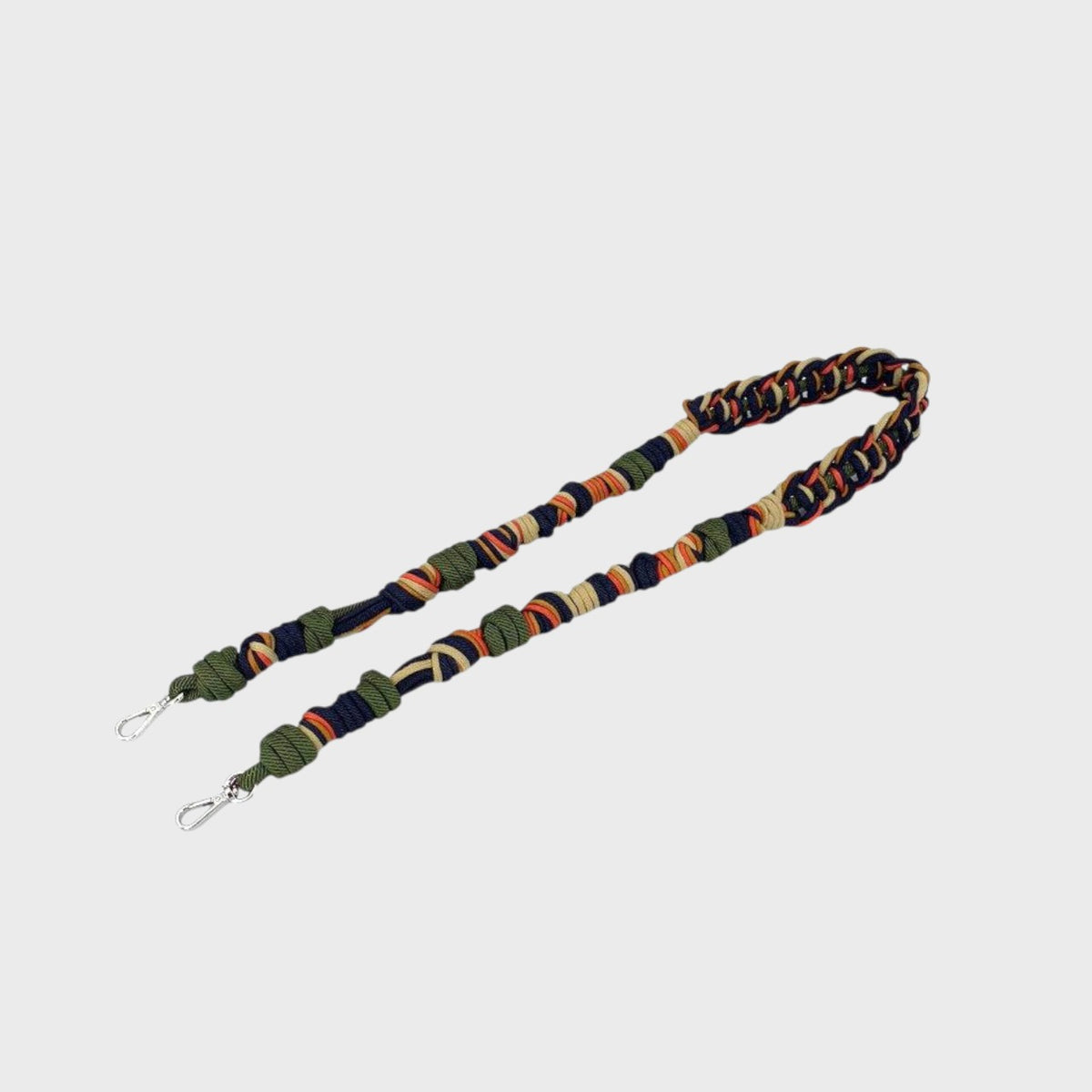 Colorful macramé bag strap on a light gray background