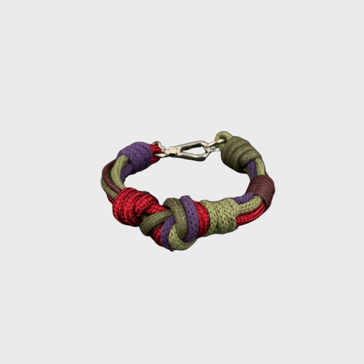 Multicolored braided bracelet on a light gray background