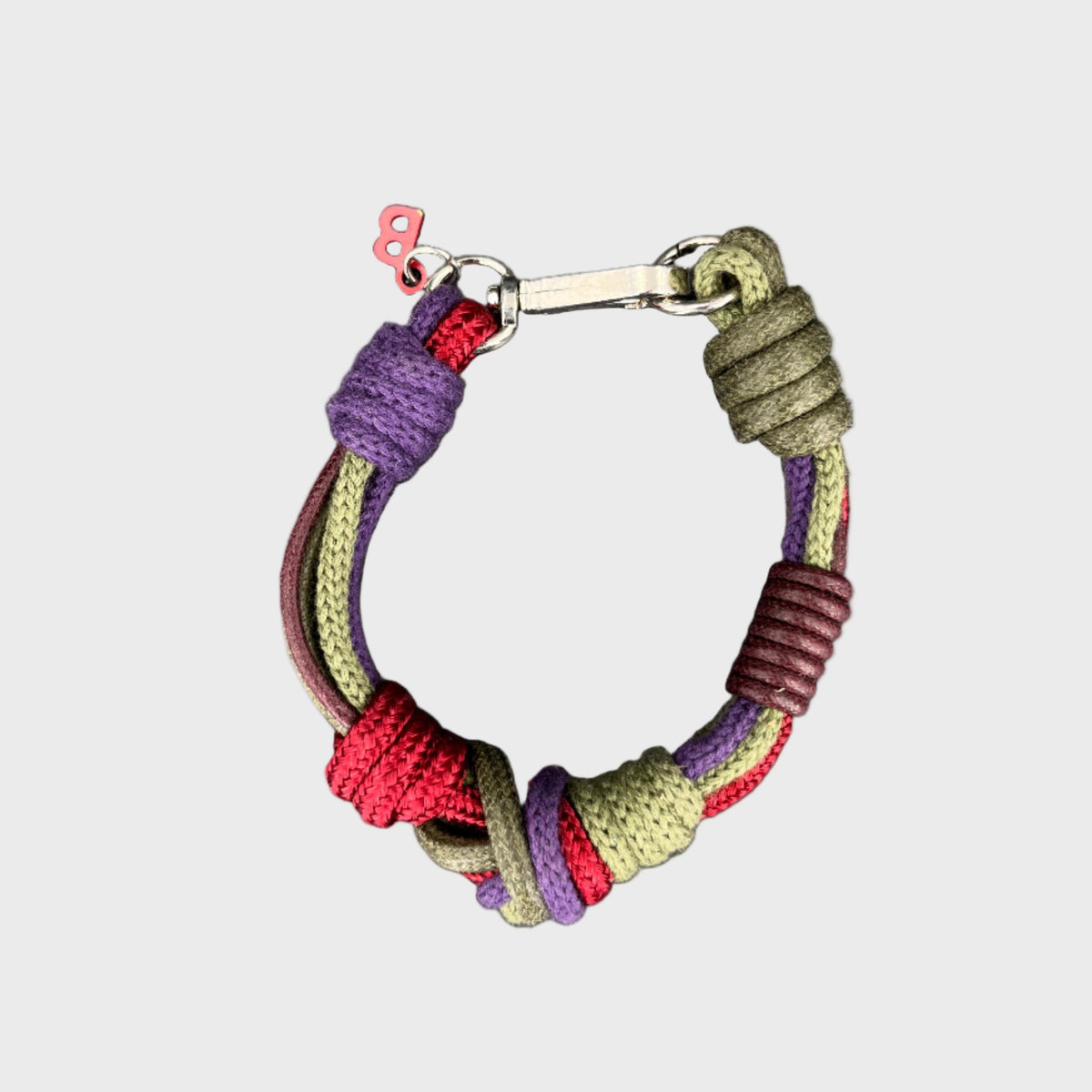 A purple, pink, green and brown bracelet from above.