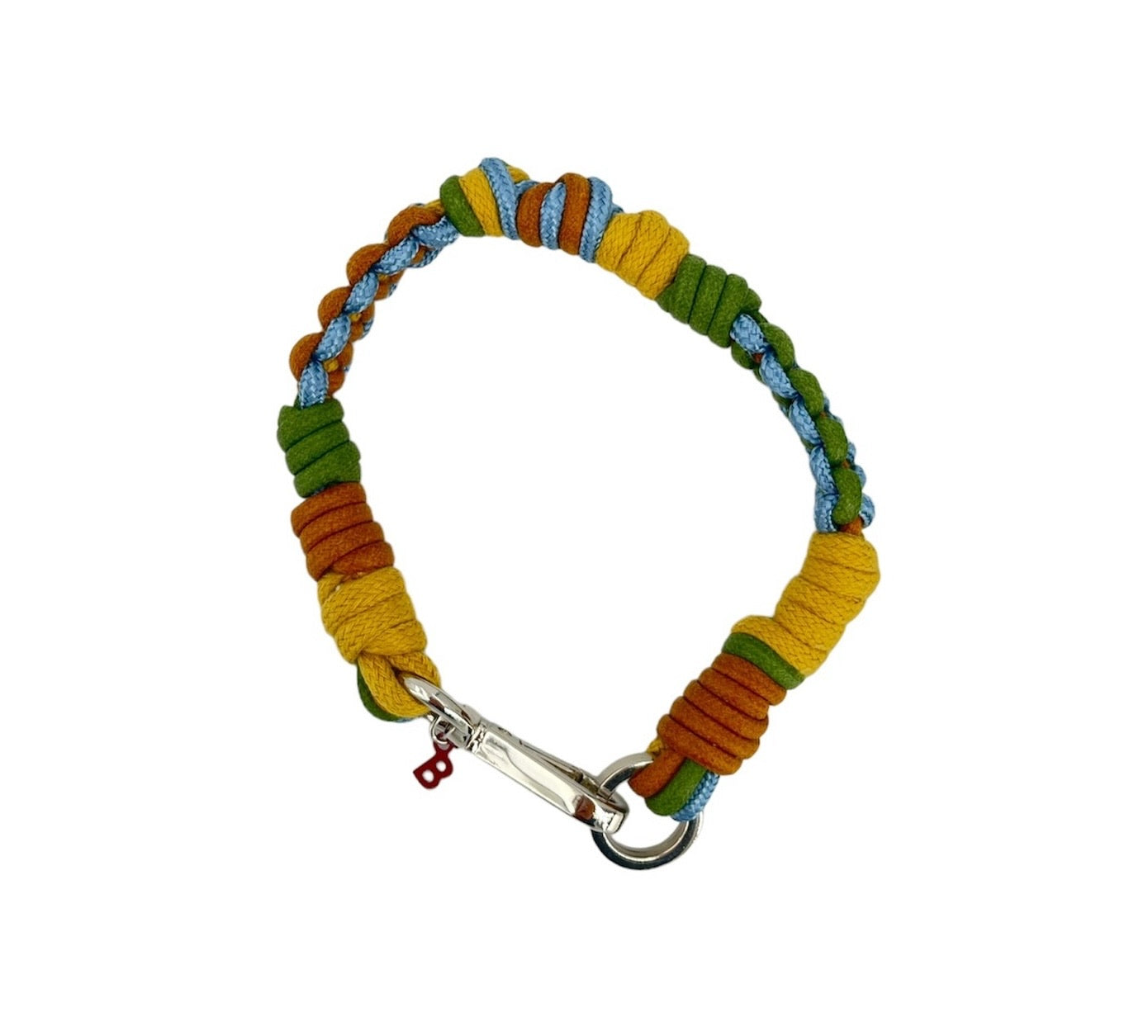 A photo taken from above of a braided macramé cord collar in shades of dark, green and brown with a silver clasp.