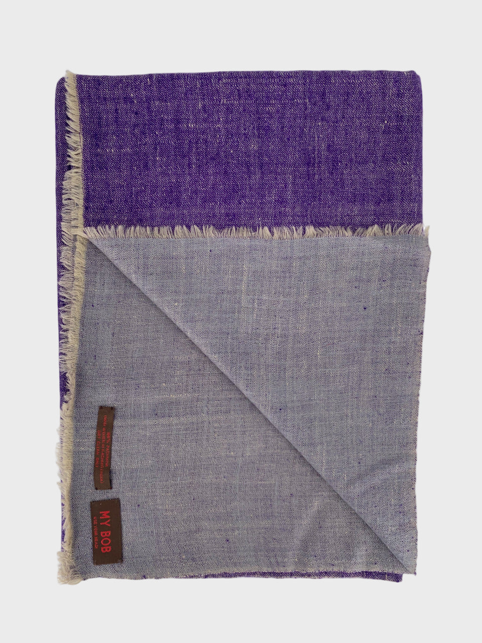 Purple and grey cashmere shawl folded on a white background