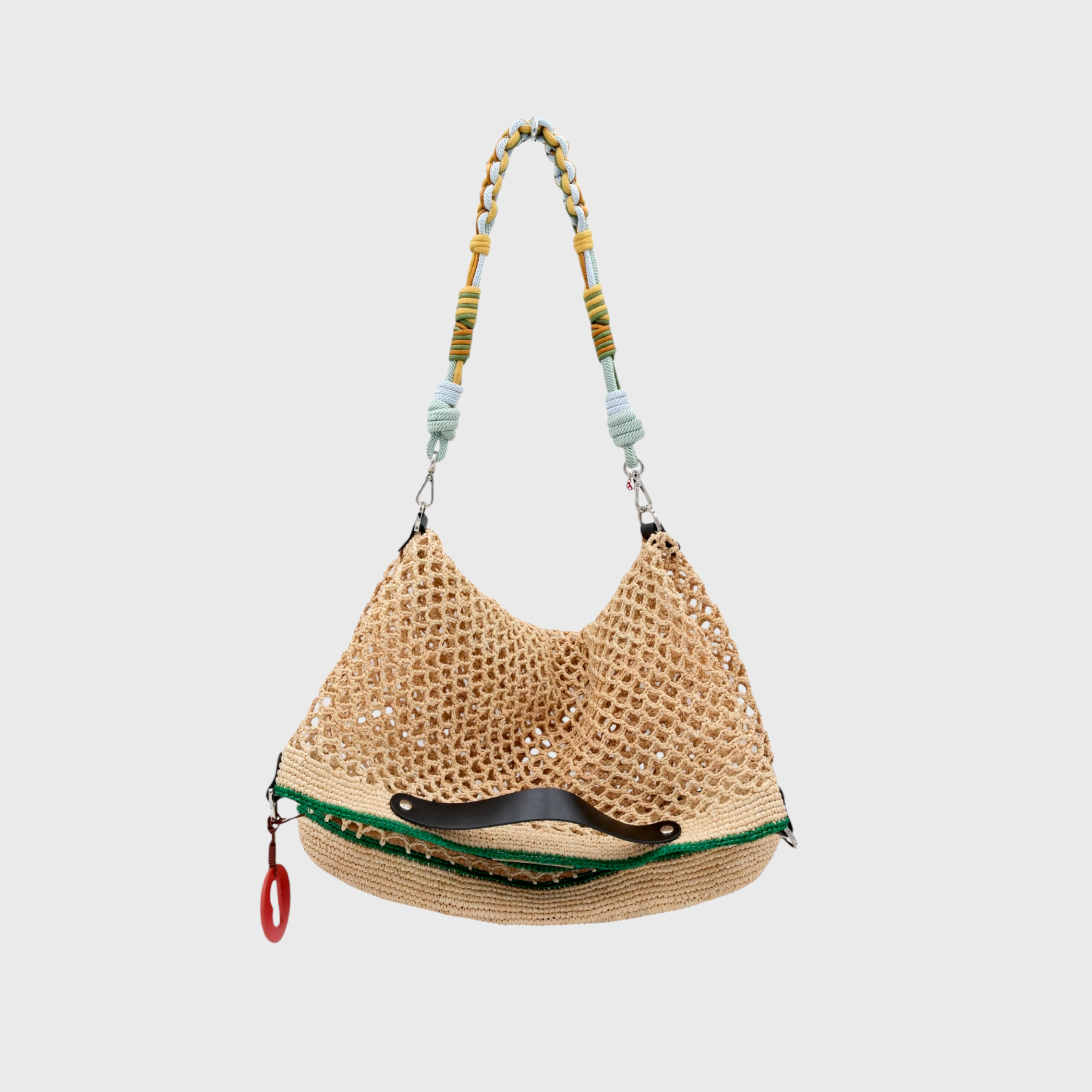 A white raffia Colin Tote Bag with green stripes, hanging by a green, light blue and yellow beaded bag strap.
