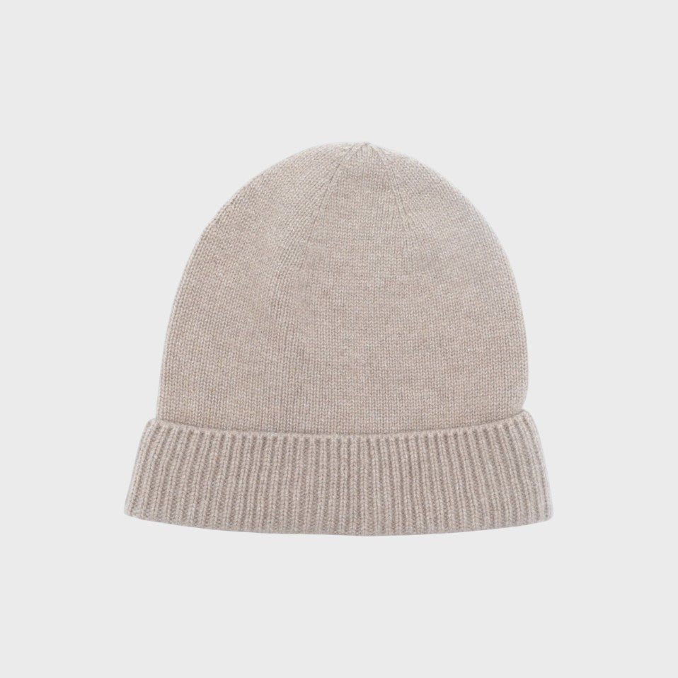 Beige cashmere knit bonnet on a light gray background