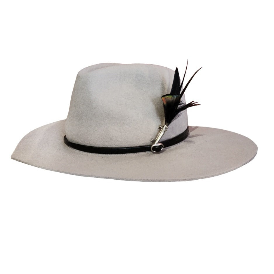 A velvet hat with a black leather band and a black feather brooch. The hat is shaped as a heart.