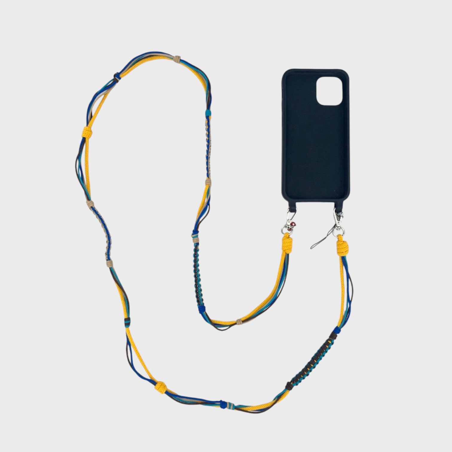 Yellow, blue, green, beige and brown macramé woven phone lanyard with a black phone case on a white background.