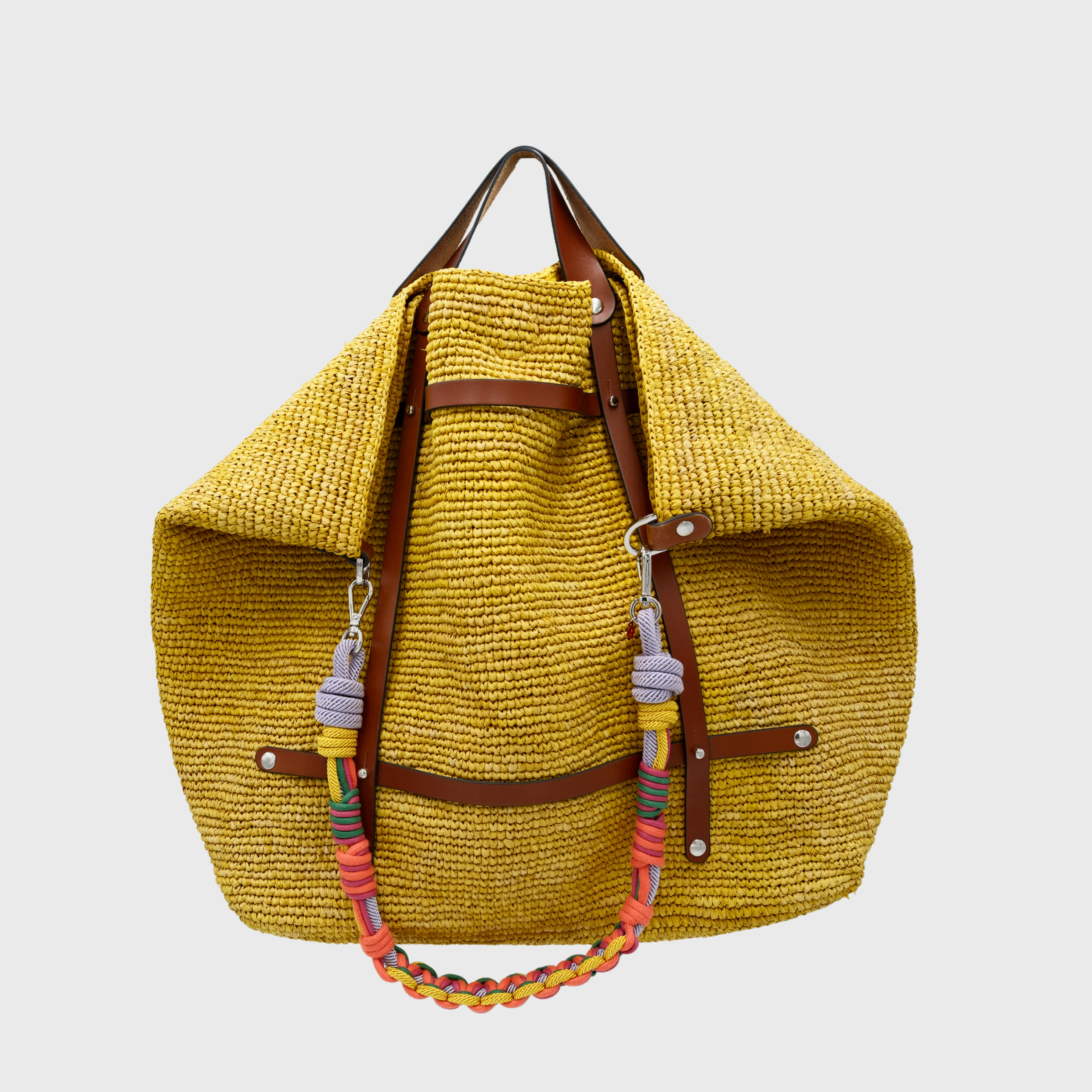 Yellow raffia weekend or duffle bag with a tan leather harness, paired with a colourful shoulder strap in pink, orange, yellow and purple.