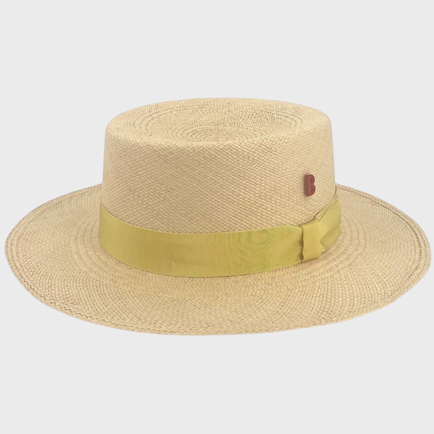 A beige straw fisherman hat with a yellow ribbon around it.