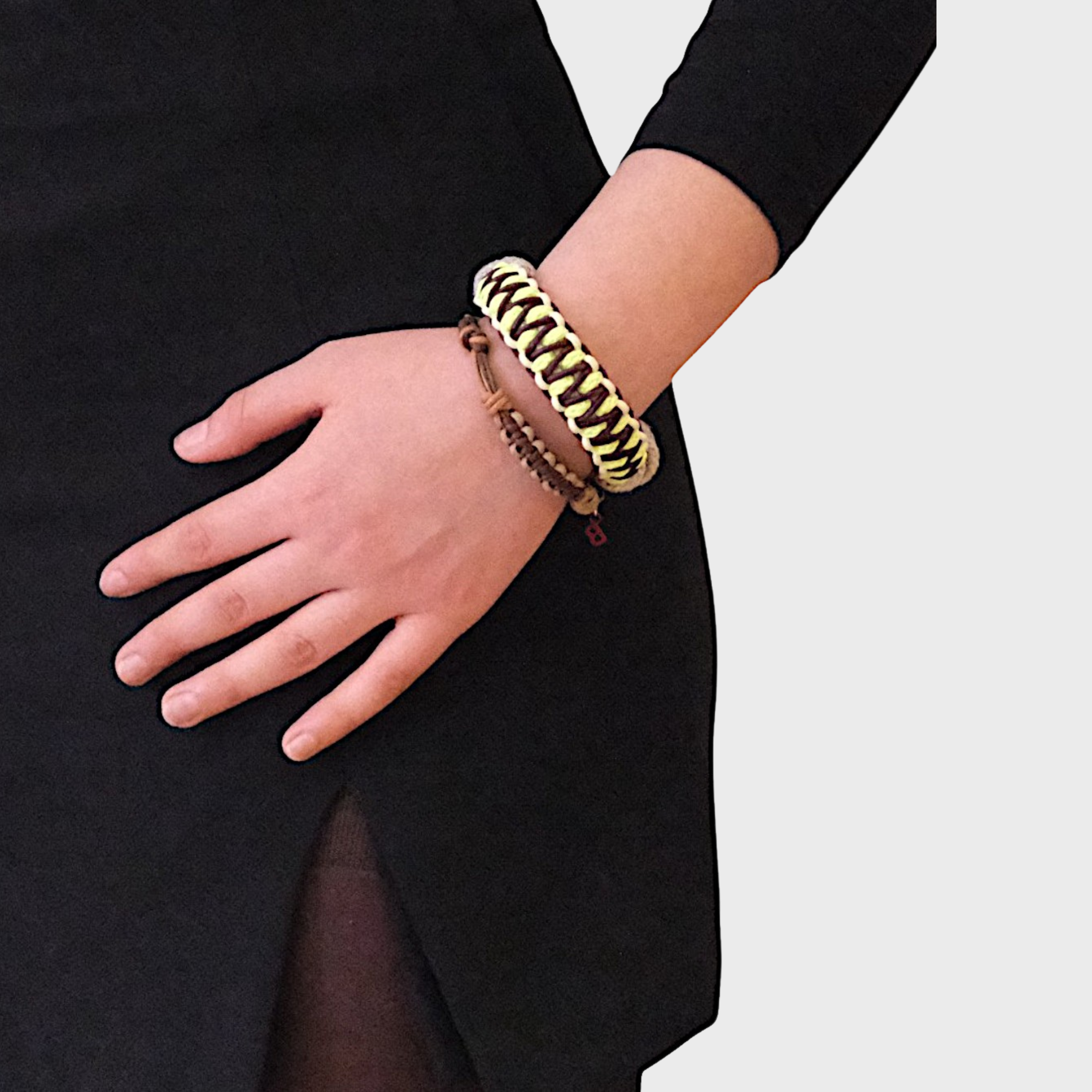 A model wearing several bracelets including the neon yellow, brown and beige Emil bracelet