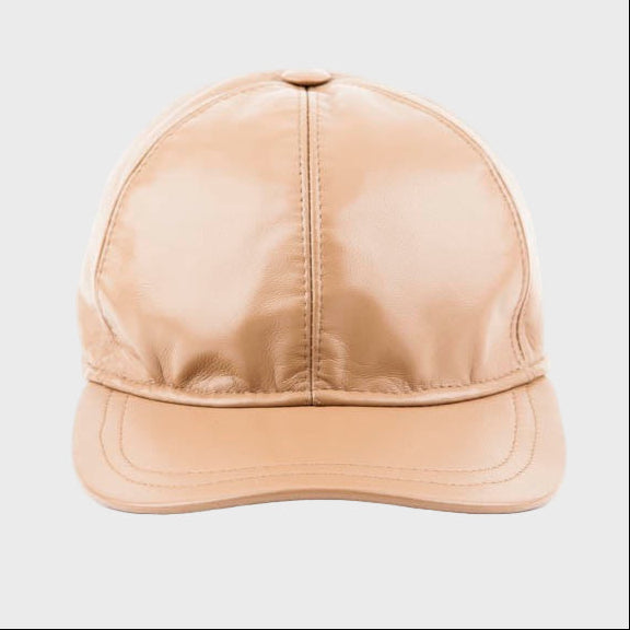 Beige leather cap on a light gray background
