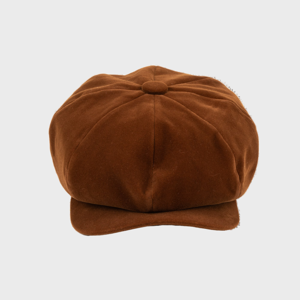 Brown suede leather newsboy cap on a light gray background