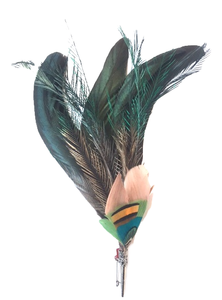 A feather brooch with dyed feather and a silver metallic clasp.