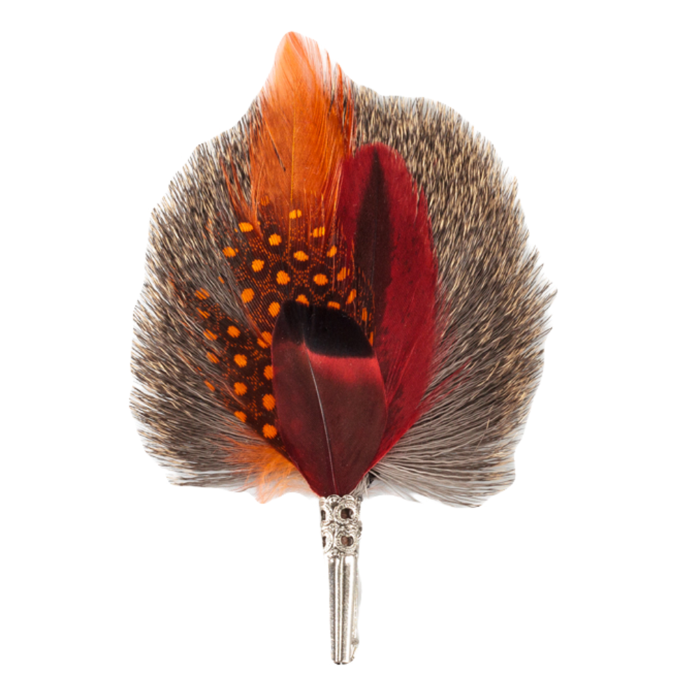 A feather brooch with a combination of brown, black, orange, and red colored feathers, mounted on a bristle base, designed to be attached to clothing or headwear.