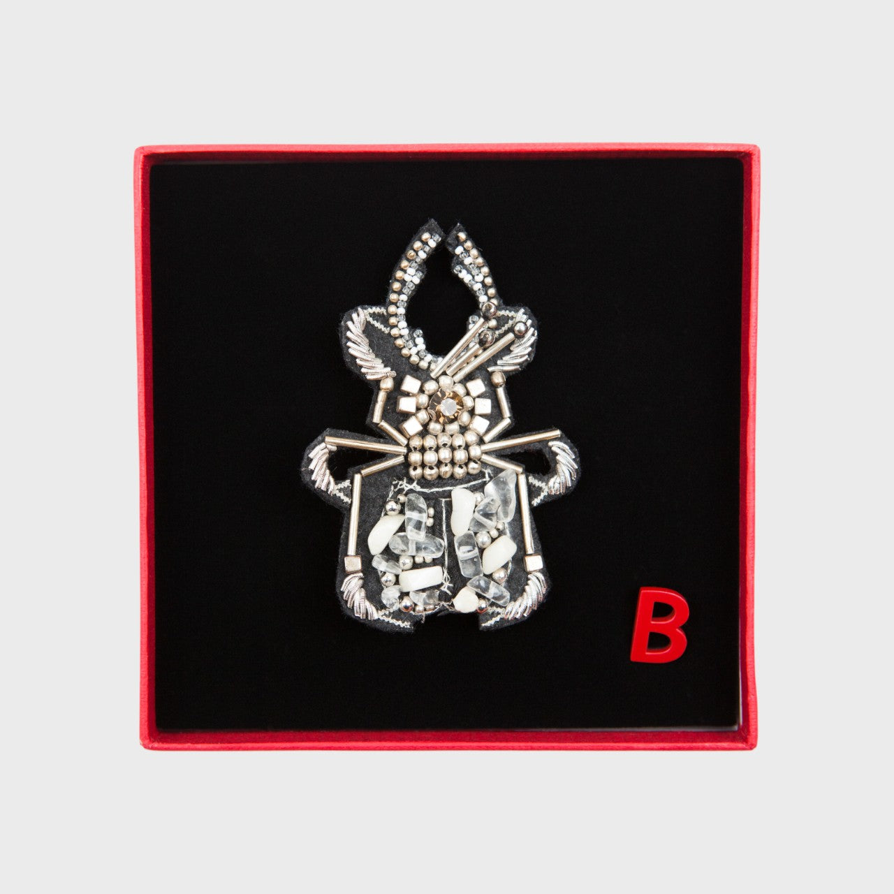 An embroidered beetle silver brooch in a box. 