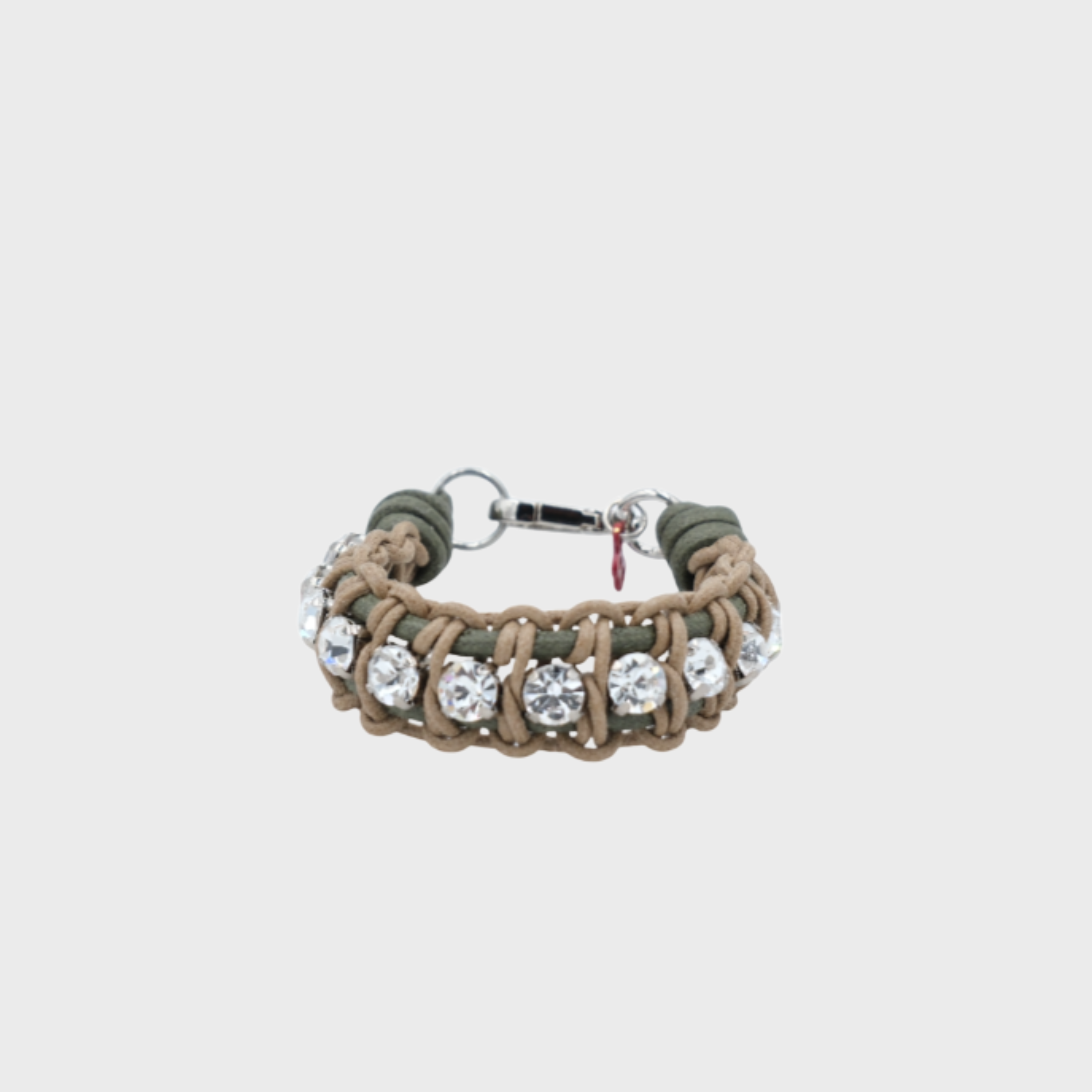 A braided macramé bracelet featuring beige and green cords with small white beads.