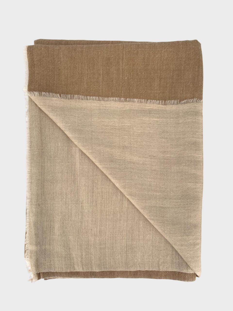 Folded cashmere shawl with beige top and beige bottom on a white background