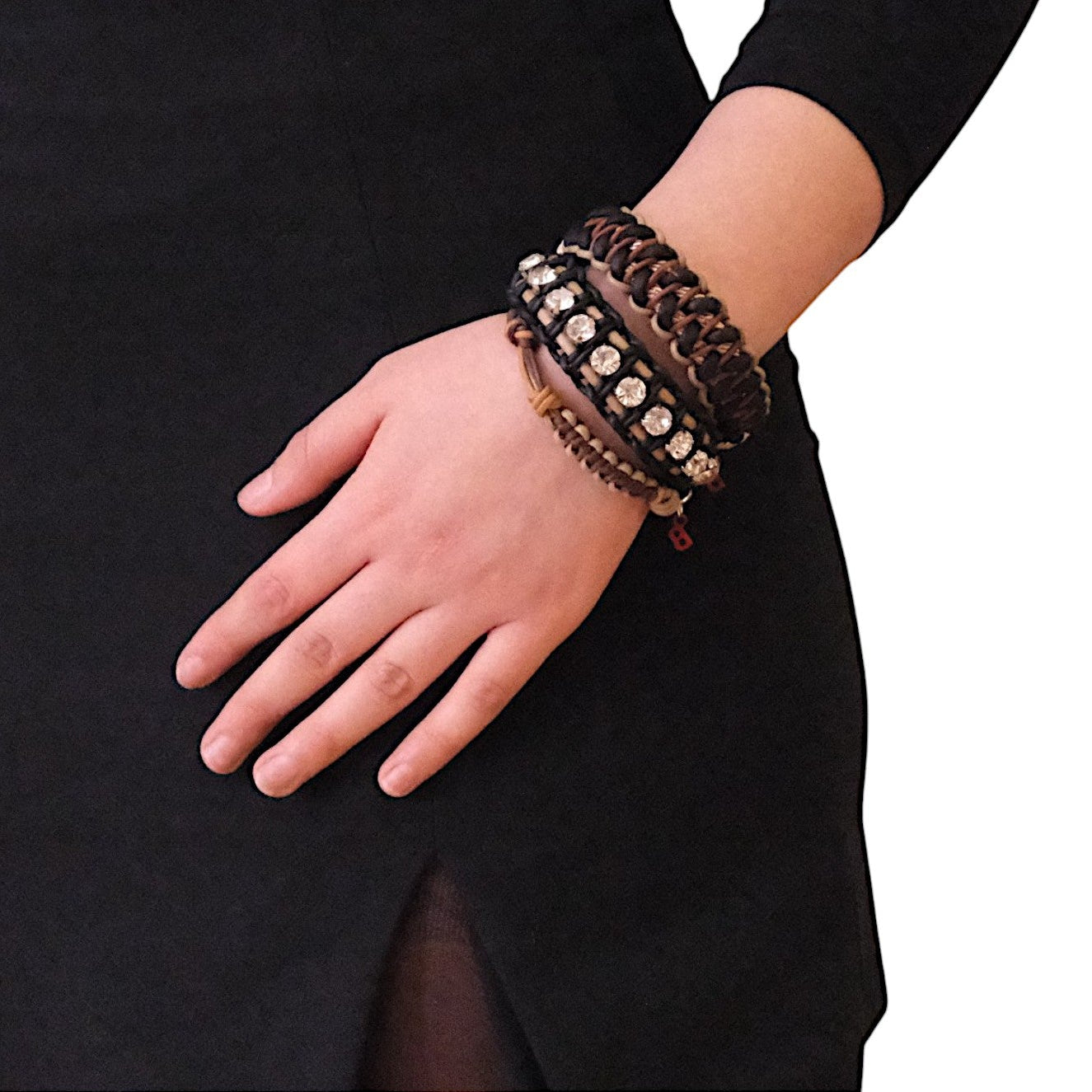 A model wearing several bracelets including the black and beige Juliette bracelet with small white beads. 