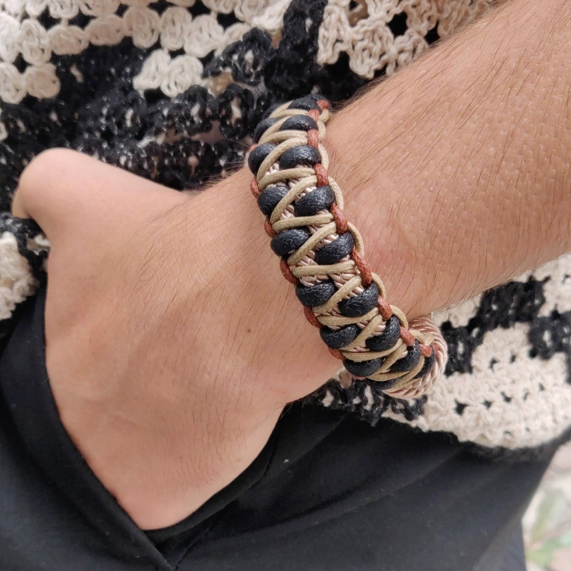 A model wearing the beige, black and brown Emil bracelet