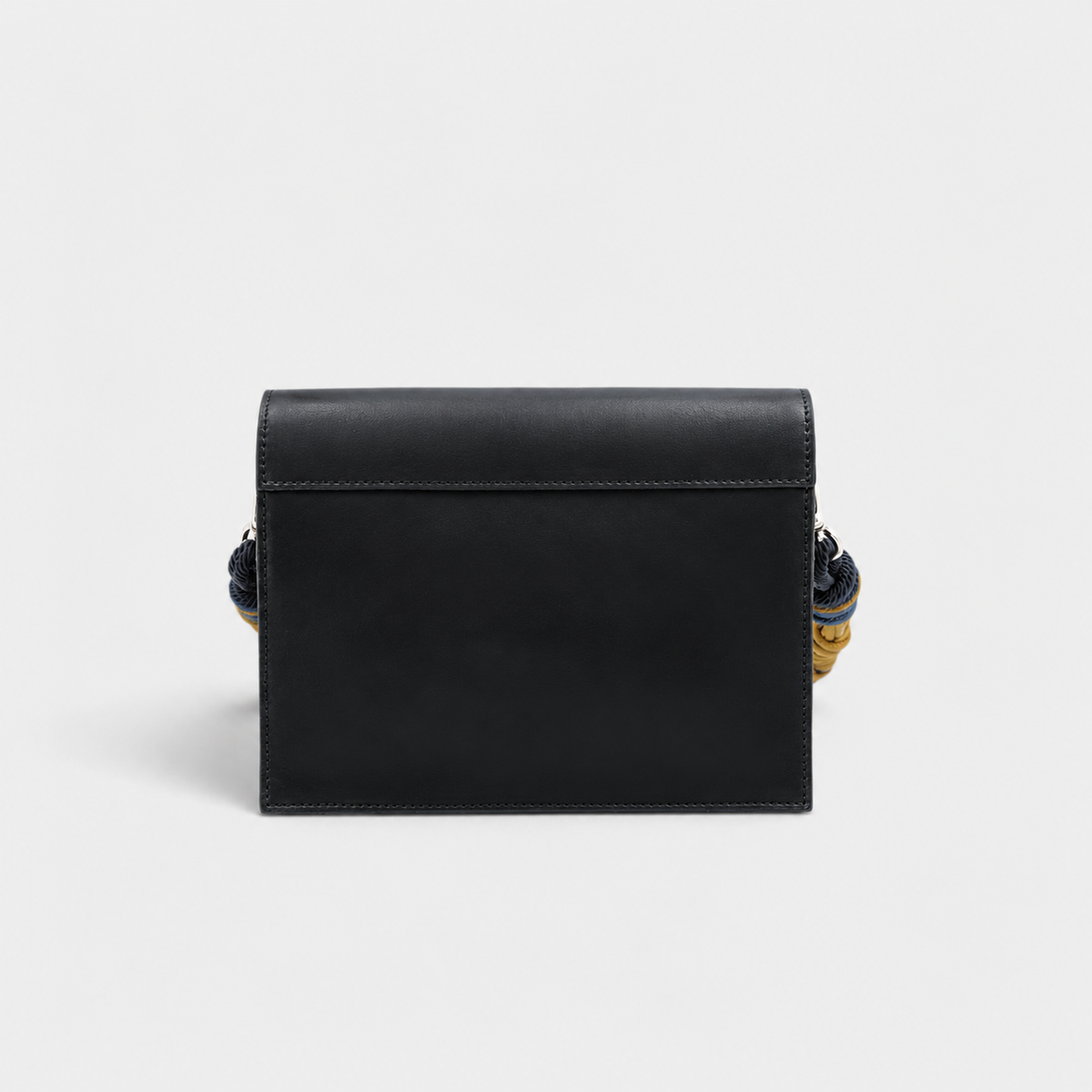 The back of a rectangular genuine leather clutch bag in a black colour, shown against a solid light gray background.