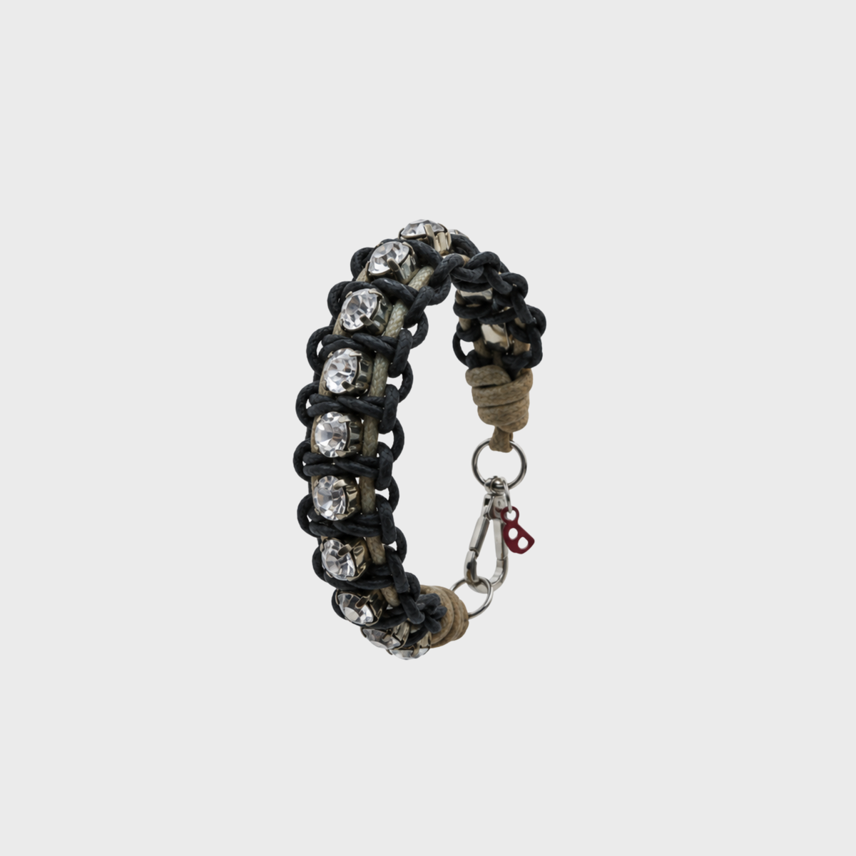 A braided macramé bracelet featuring black and beige cords with small white beads.