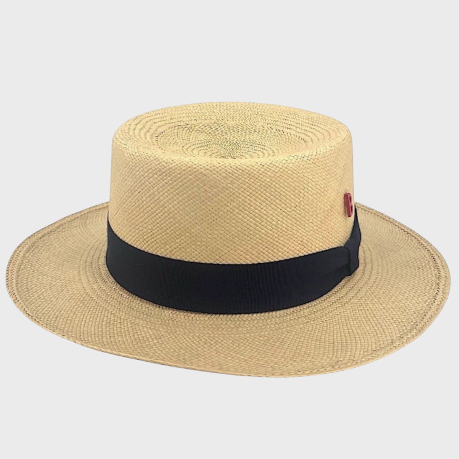 A beige straw fisherman hat with a black ribbon around it 