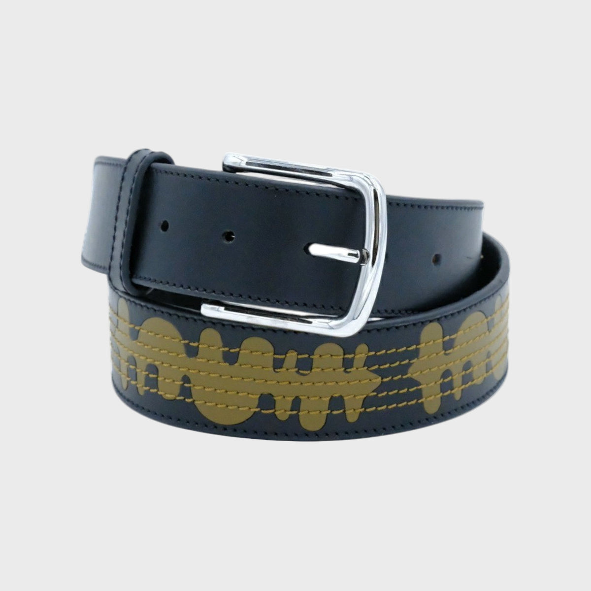 Black leather belt with gold pattern and silver buckle on a light gray background