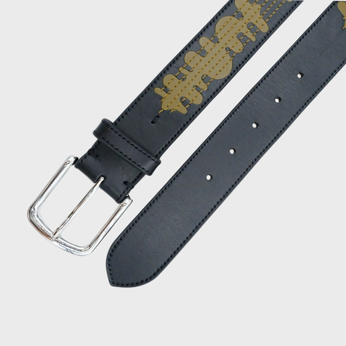 Black leather belt with gold pattern embroidered on it on a light gray background