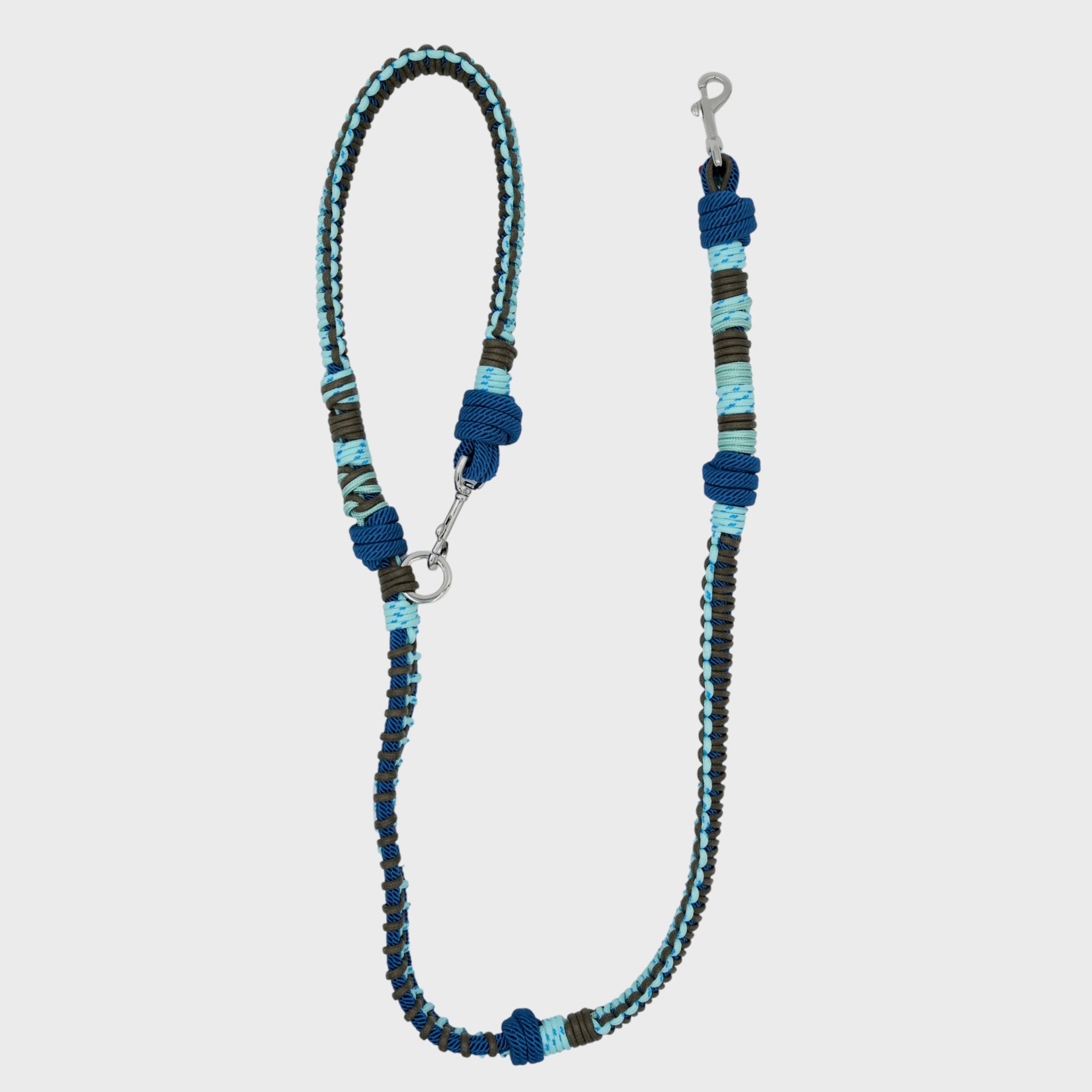 A braided macramé dog leash with dark and light blue woven sections, and a silver metal hardware.