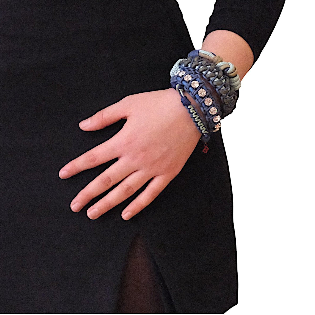 A model wearing several bracelets including the brown and dark and light blue Emil bracelet