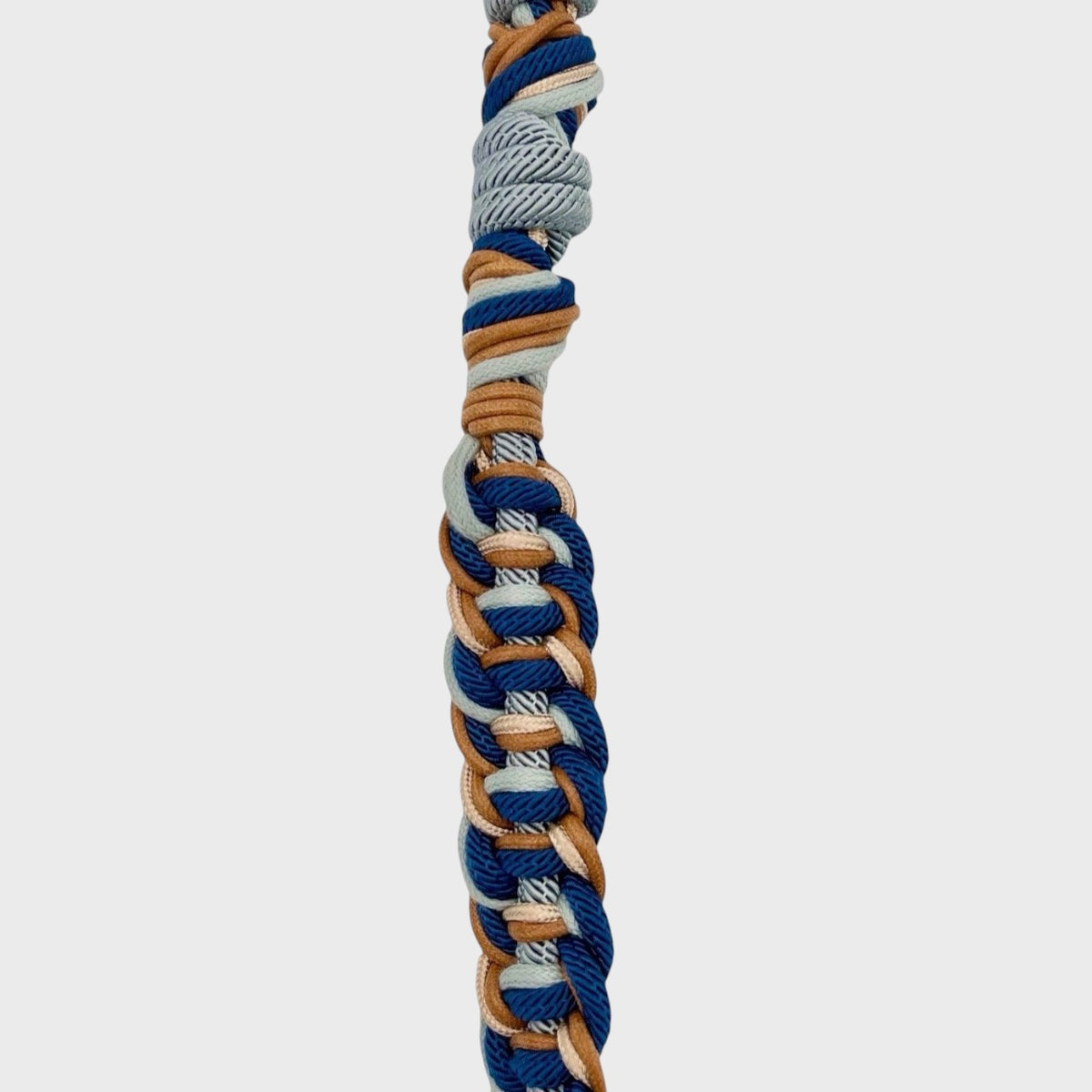 Multicolored braided bag strap on a light gray background