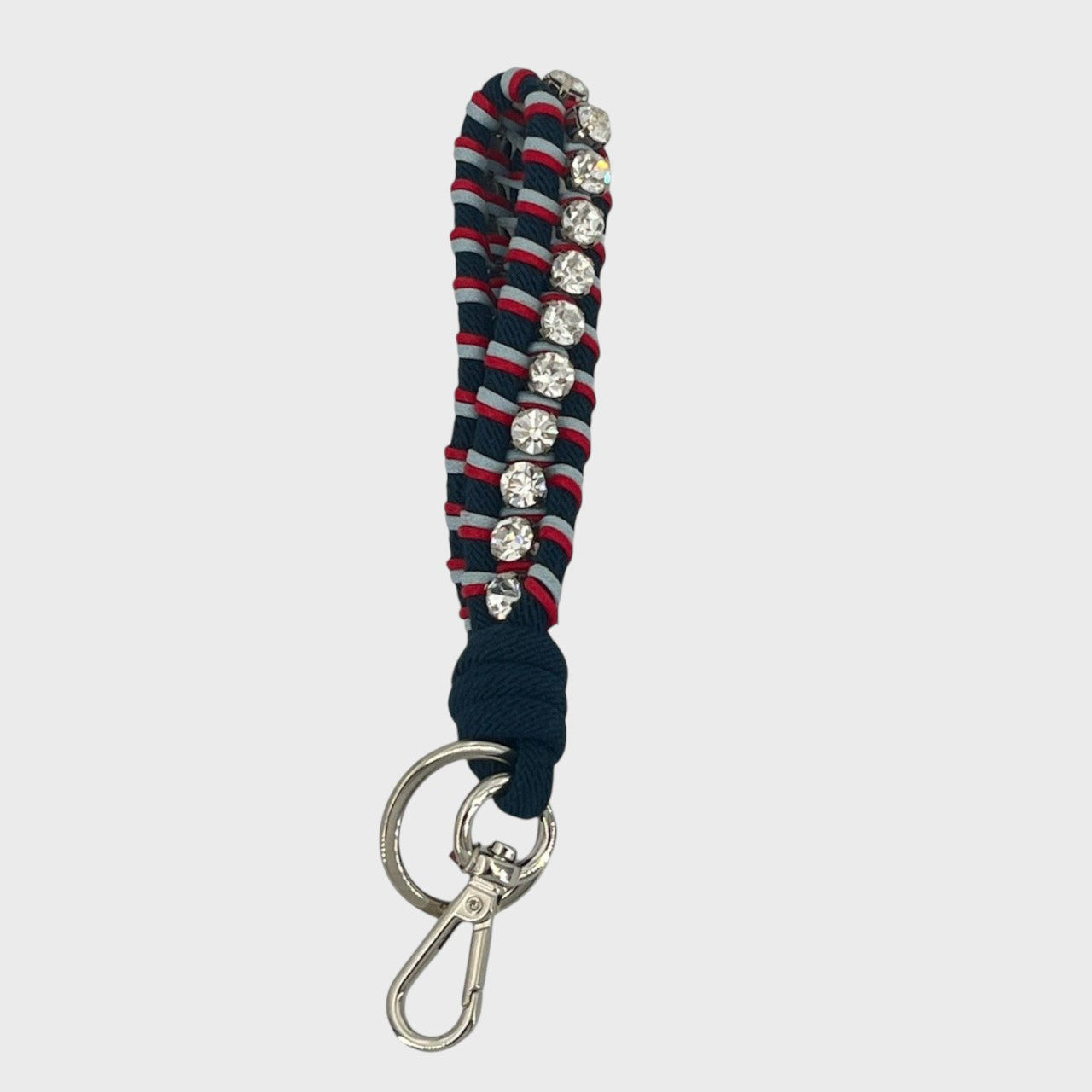 A macramé braided keychain strap featuring a dark blue and red pattern, accented with a vertical row of silver rhinestones, and finished with a silver metal lobster clasp on a light gray background.