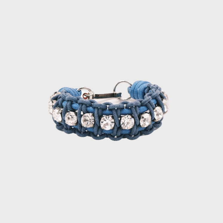A braided macramé bracelet featuring blue cords with small white beads.