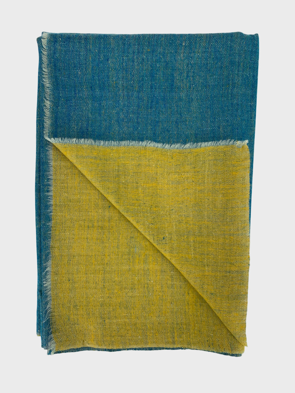 Folded cashmere shawl with blue and yellow on a white background