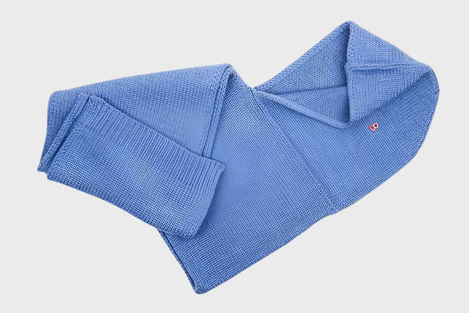 Blue wool hat scarf on a light gray background
