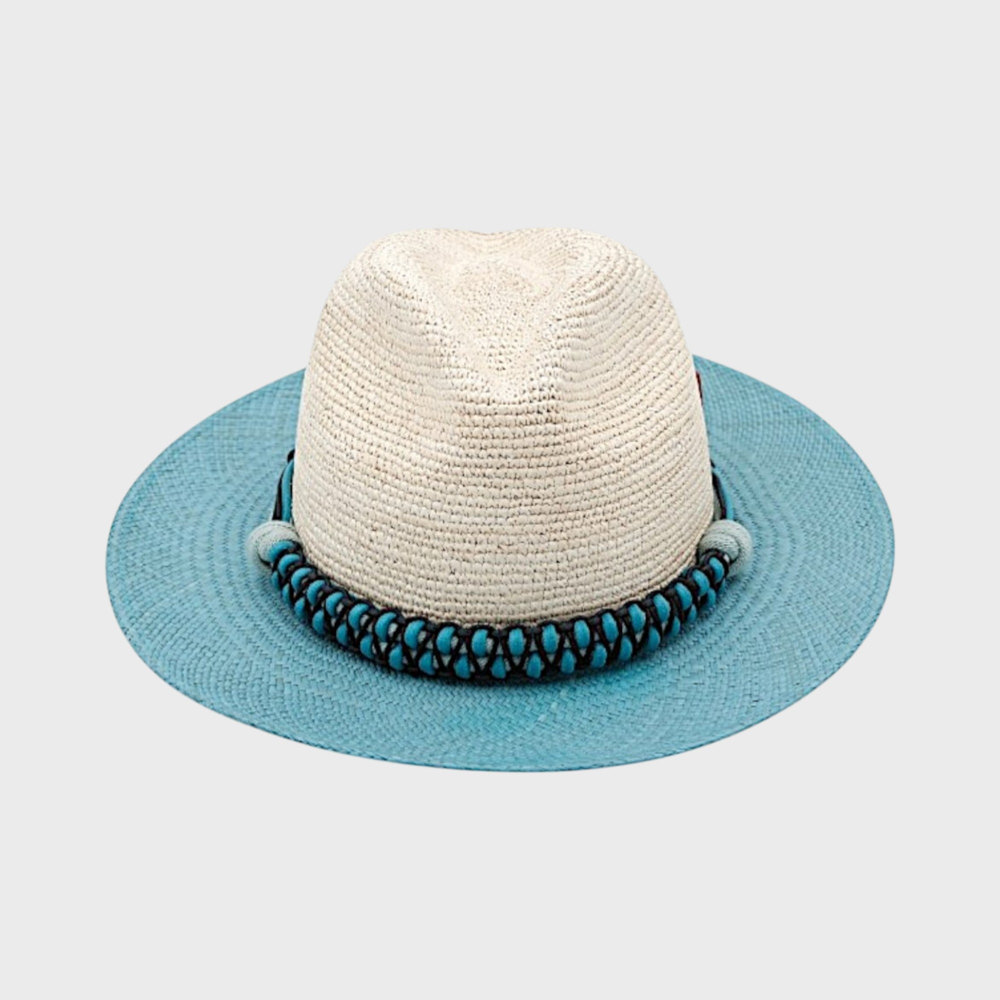 A white and blue raffia hat with a blue macramé band around, facing the camera