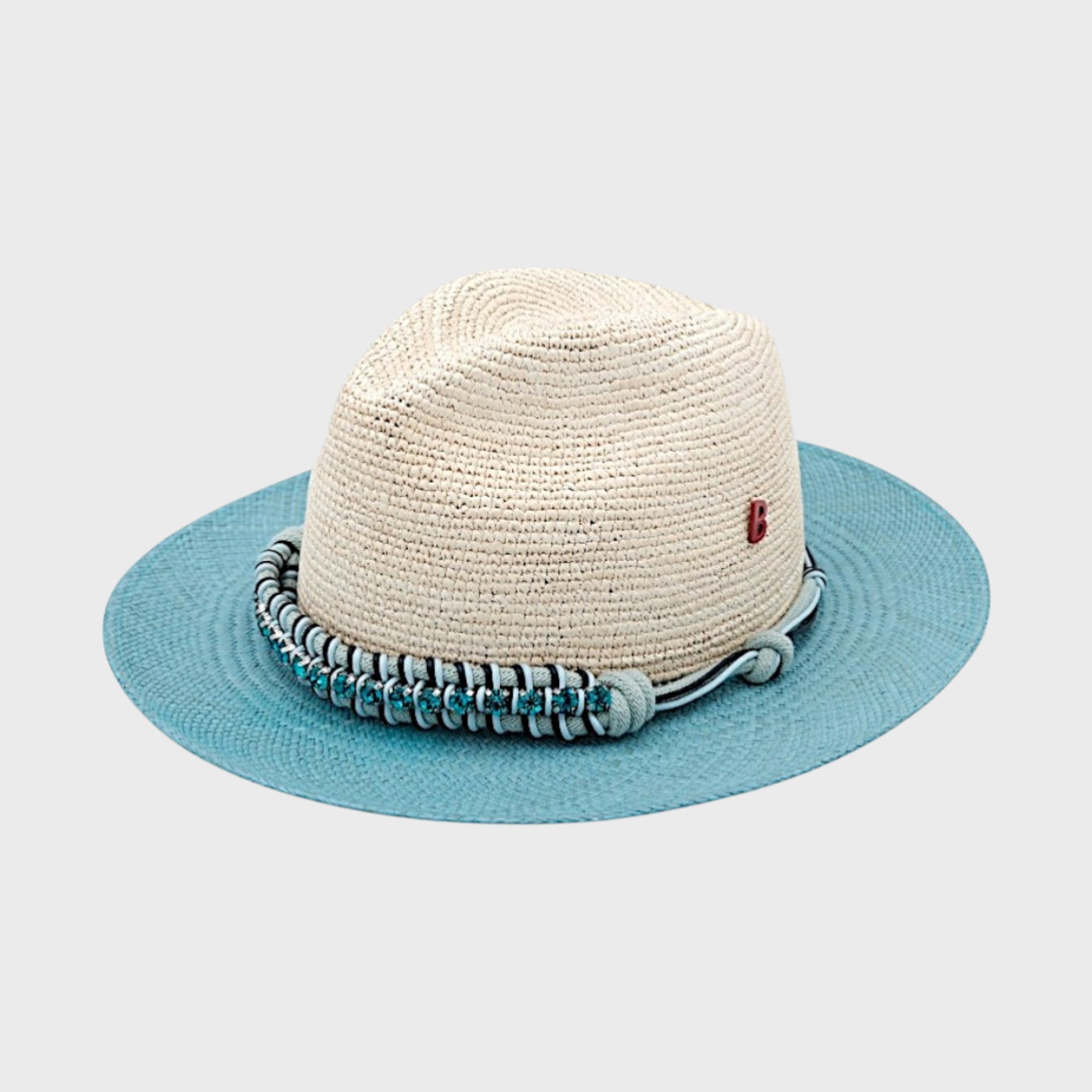 A white and blue raffia hat with a blue macramé beaded band around it. 