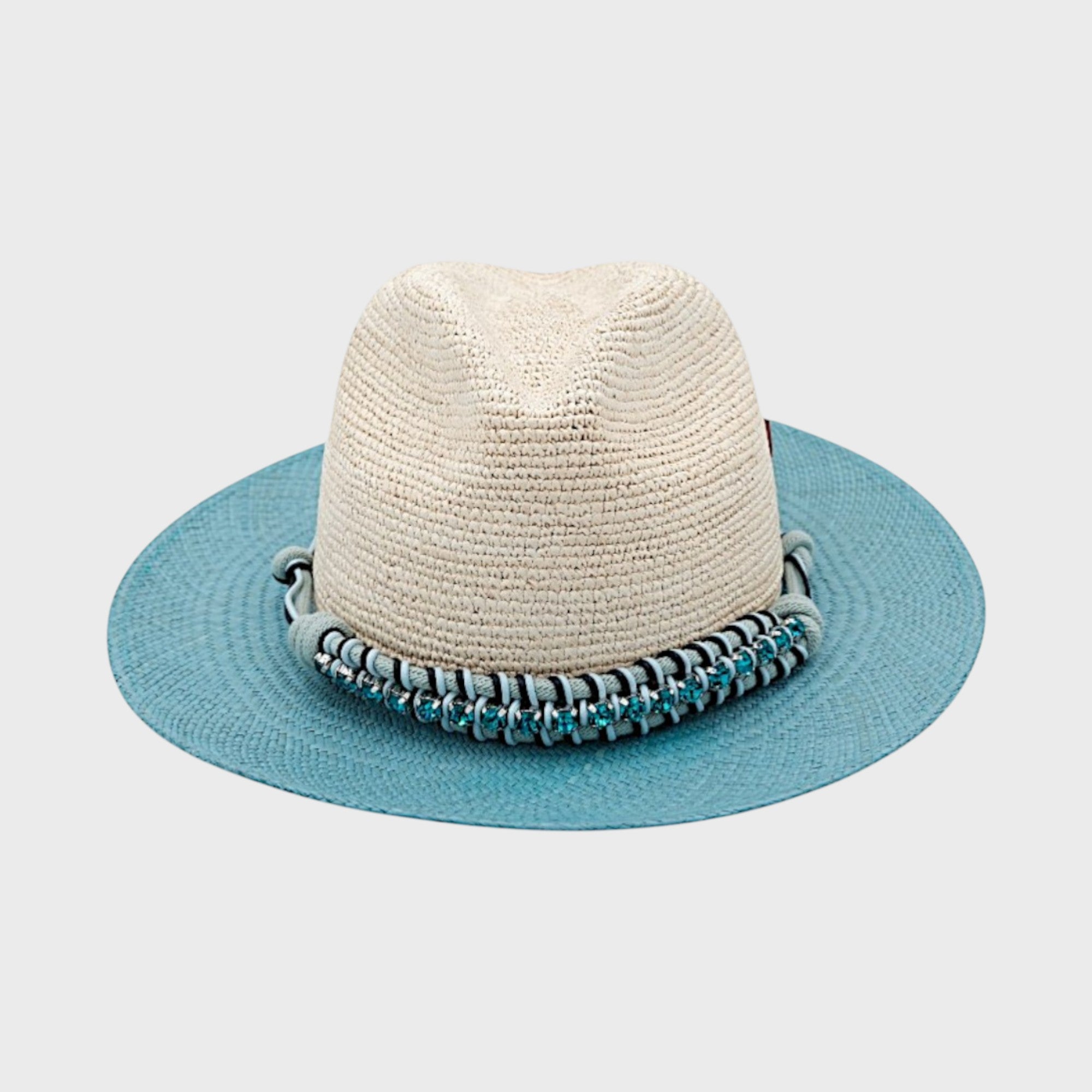 A white and blue raffia hat with a blue macramé beaded band around it facing camera. 