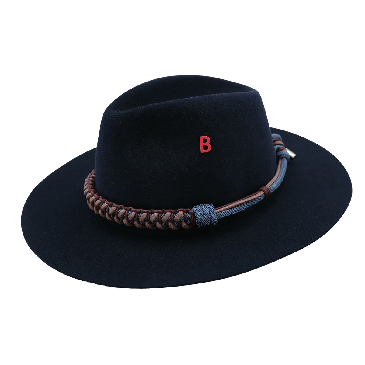 Navy blue fedora hat with braided macramé band and red letter 'B' pinned on it on a white background