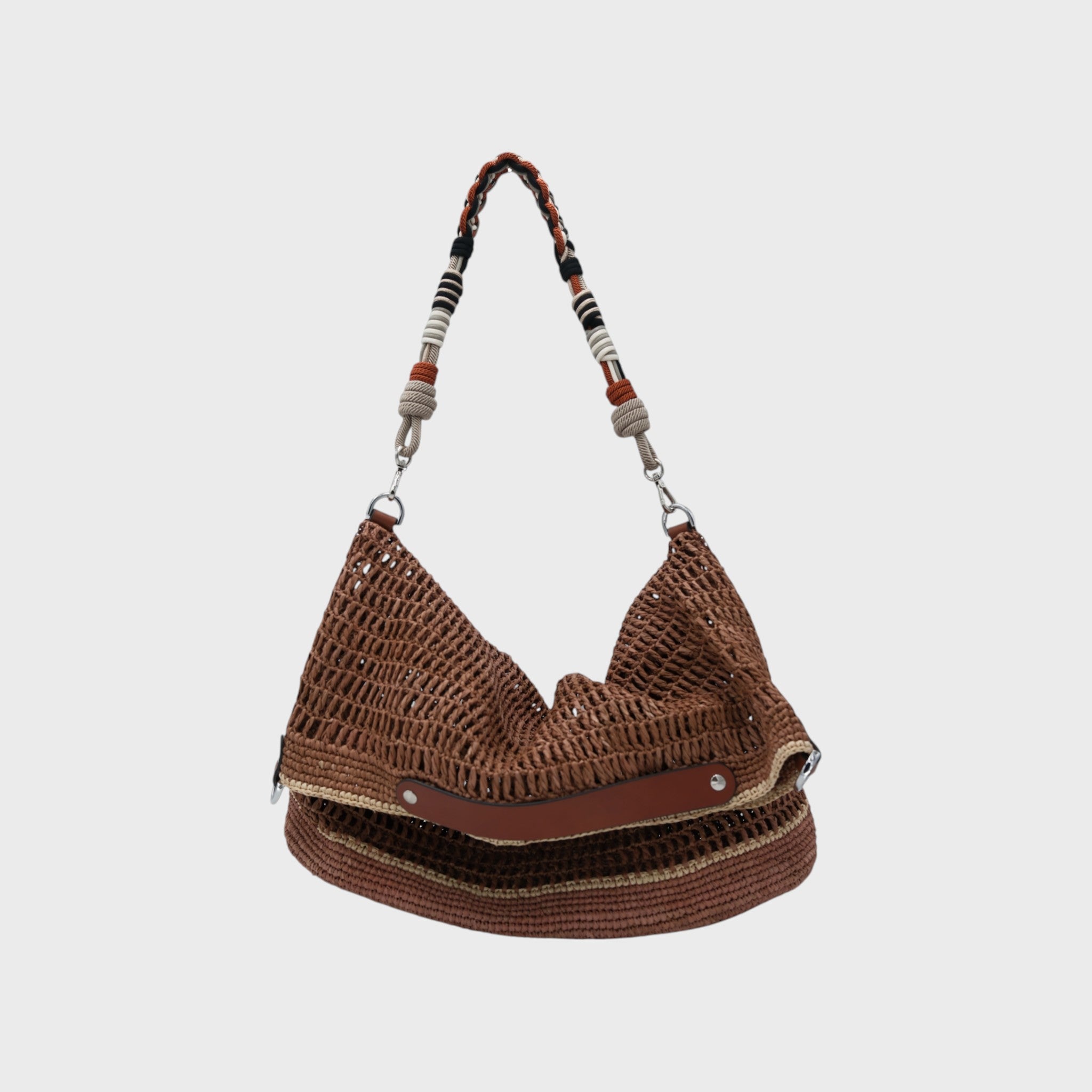 A Brown raffia Colin Tote Bag with beige stripes, hanging by a orange, black and grey beaded bag strap. 