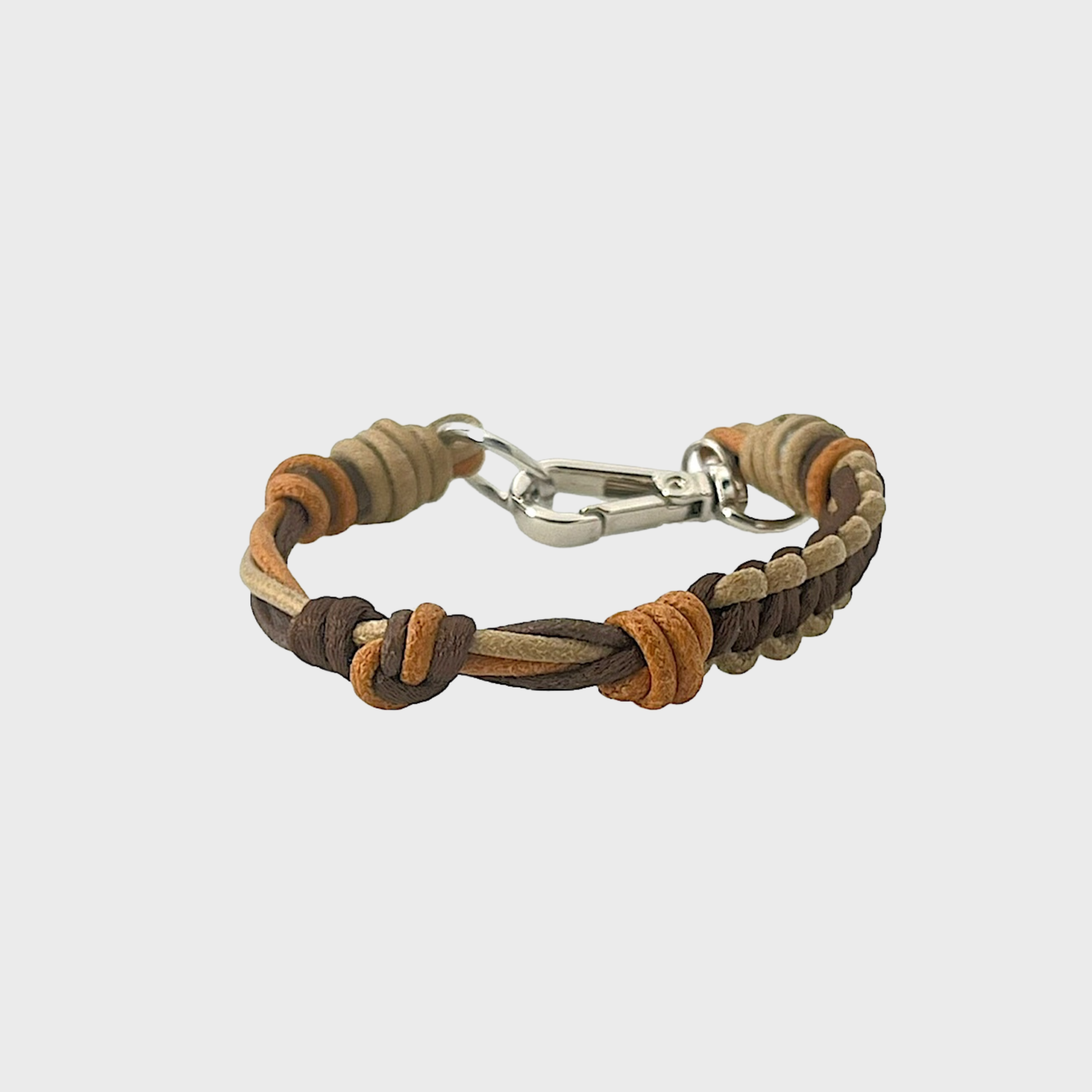 A thin braided bracelet with brown and beige macramé, featuring a silver metal  clasp. 