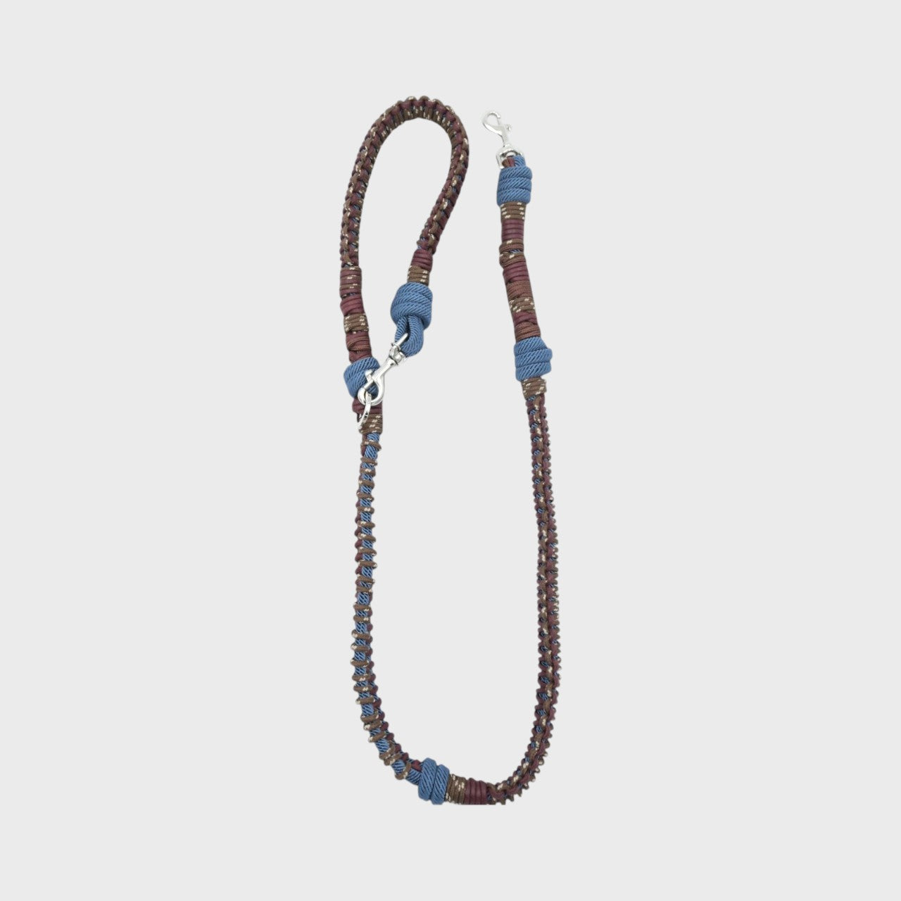 A braided macramé dog leash with brown, and blue woven sections, and a silver metal hardware.