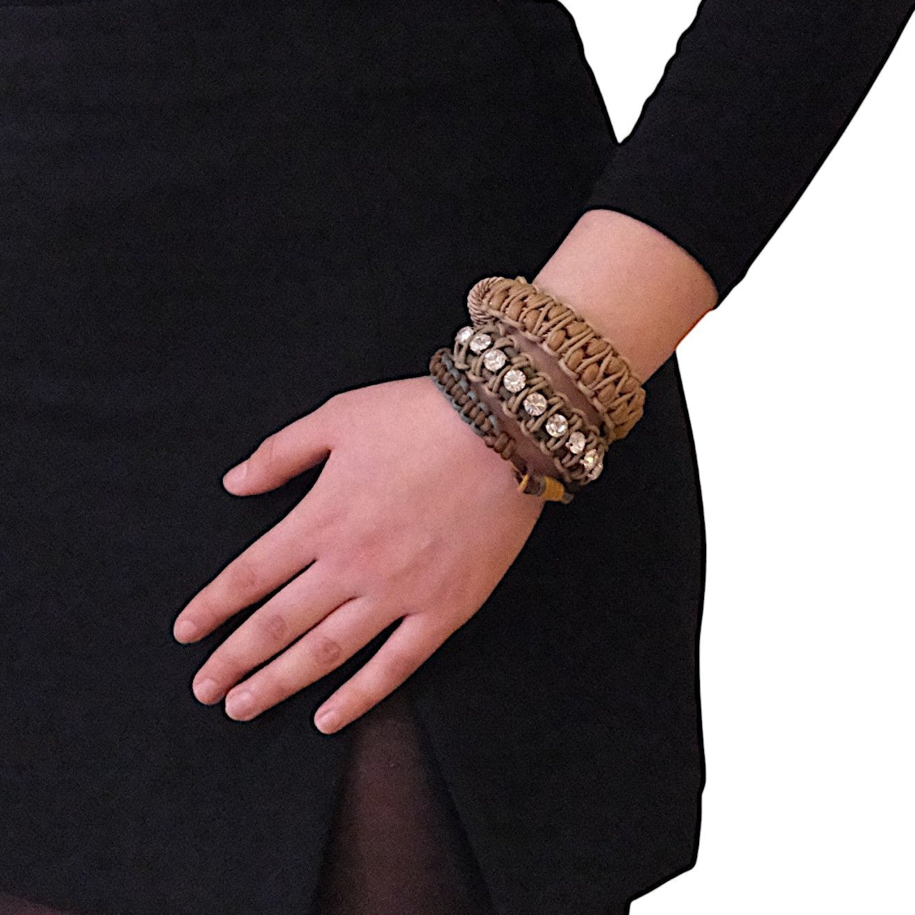 A model wearing several bracelets including the brown and light brown Emil bracelet
