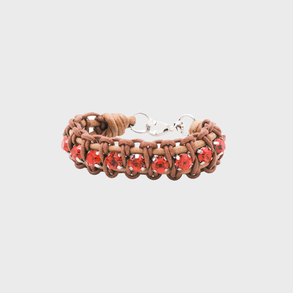 A braided macramé bracelet featuring brown cords with small red beads.