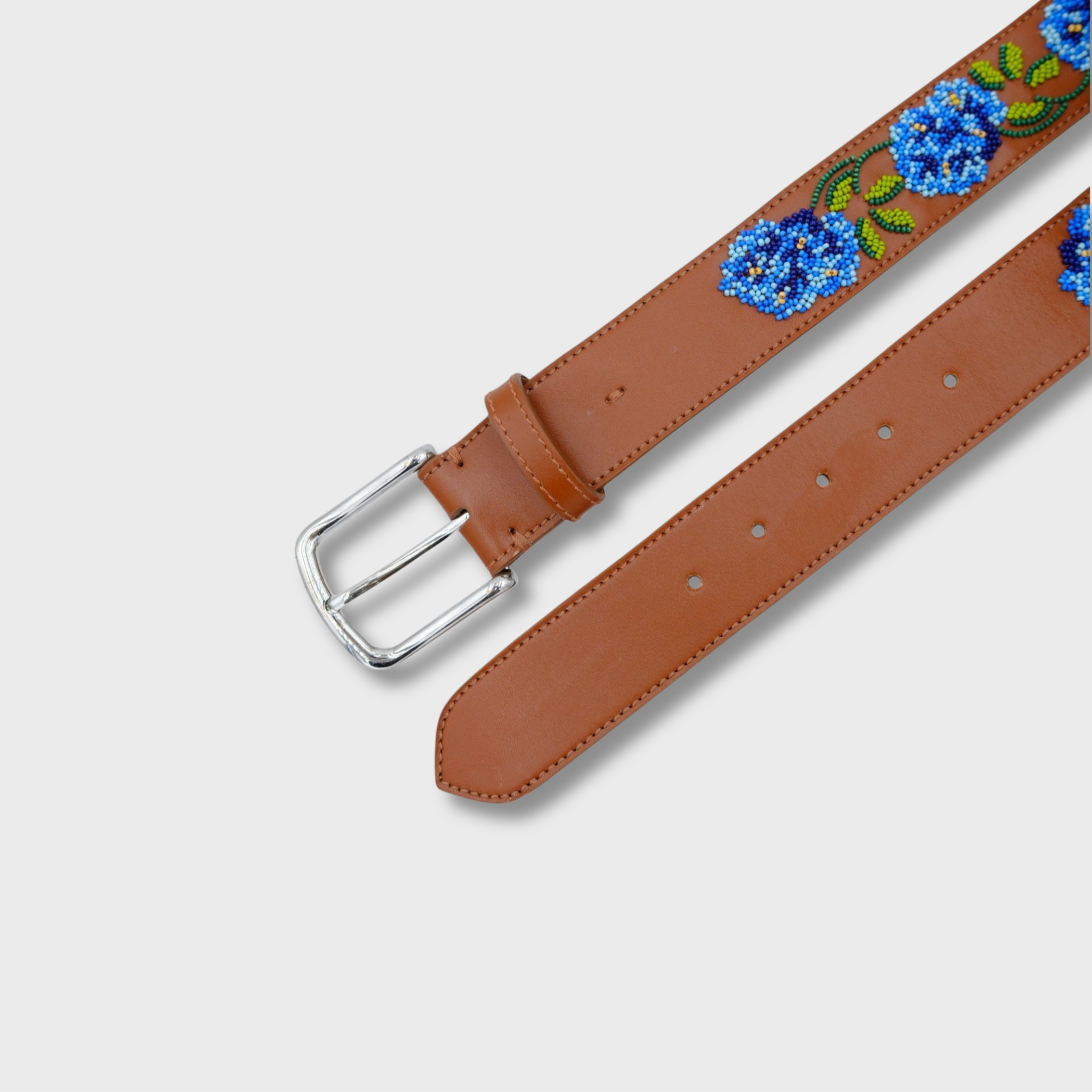 Close-up of the Blues with Cognac Flower belt showing leather and bead detail