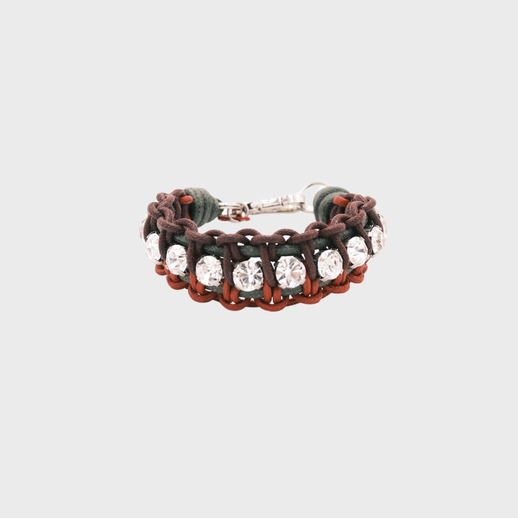 A braided macramé bracelet featuring green, burgundy and red cords with small white beads.