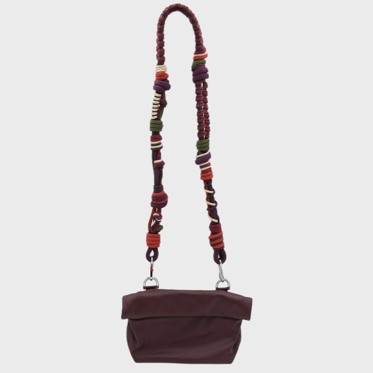 Burgundy handbag with a colorful macramé strap on a light gray background