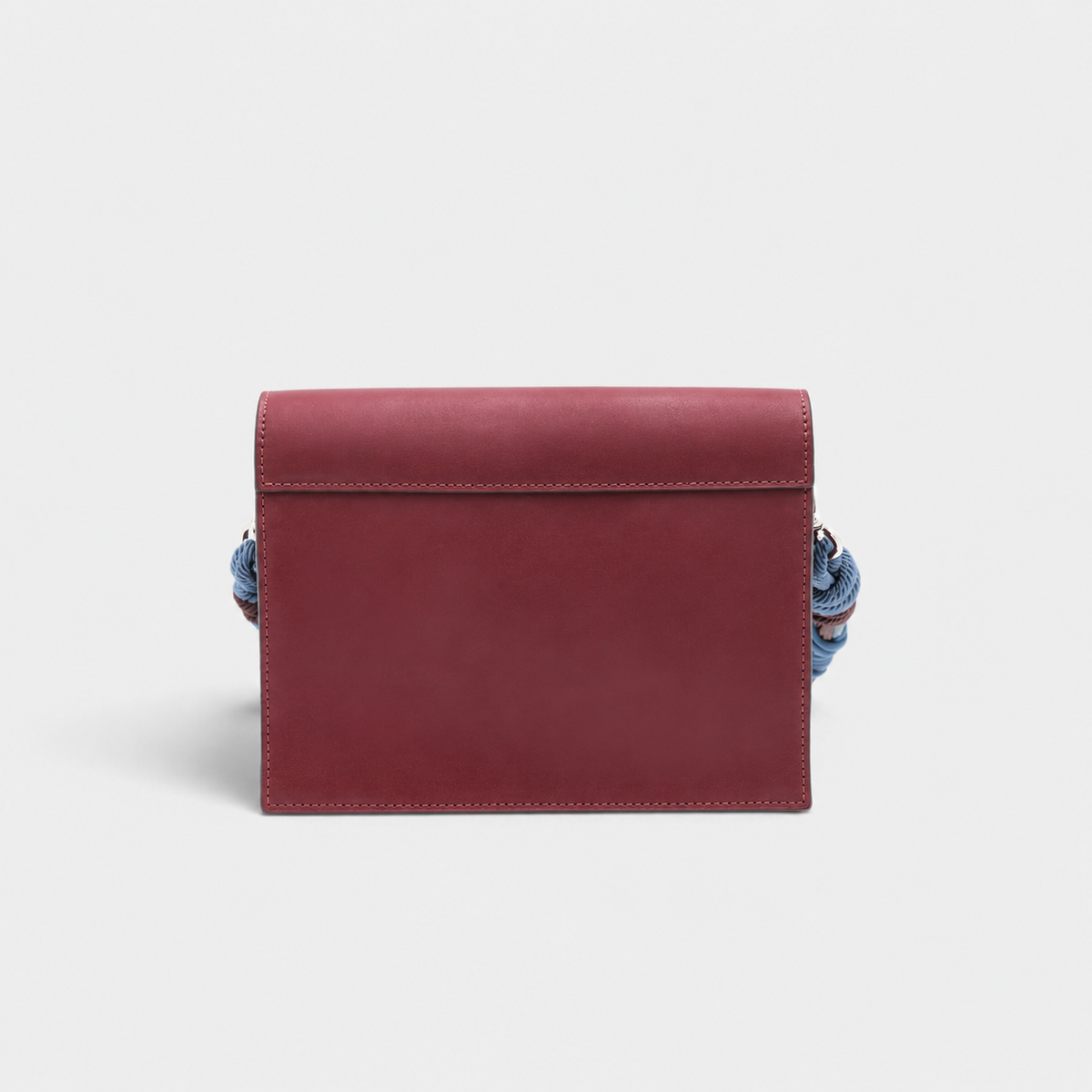 The back of a rectangular genuine leather clutch bag in a burgundy colour, shown against a solid light gray background.