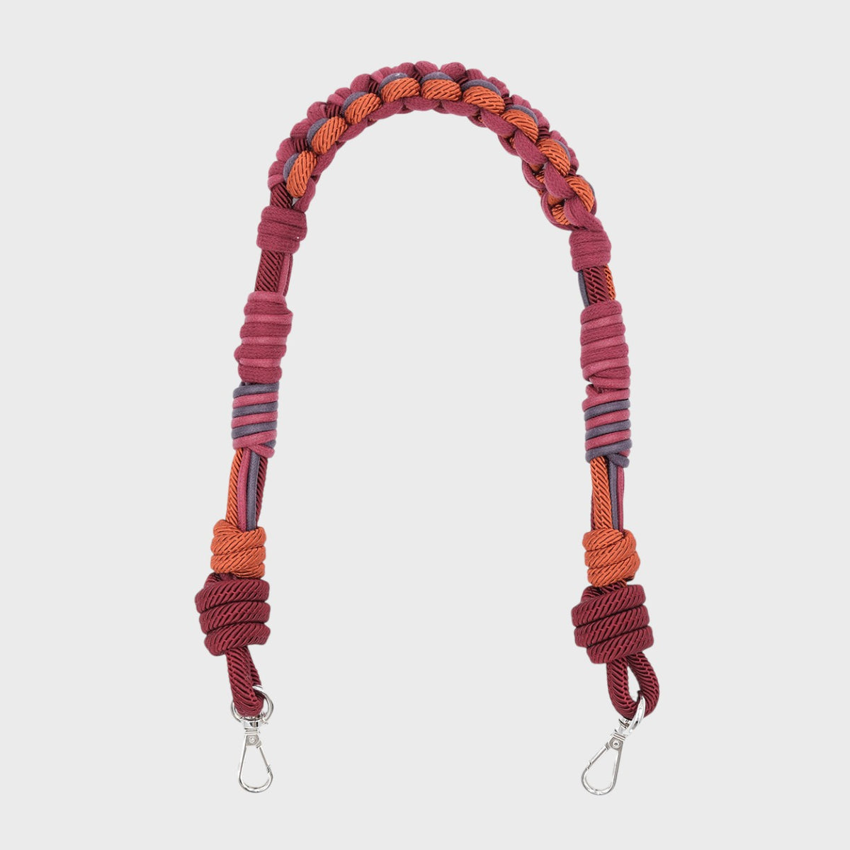 Burgundy macramé woven bag strap with metal clasps on a white background